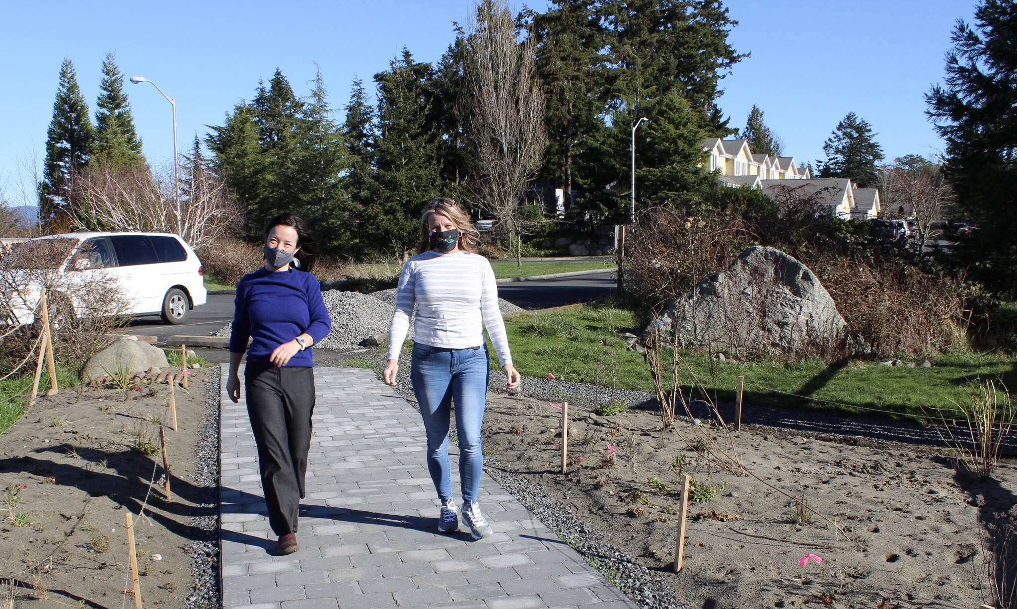 Joyce L. Sobel Family Resource Center staff members Delphina Liles and Mary Uri walk along the new back sidewalk with new landscaping to connect the food bank and family resource center to the Mullis Senior Center parking lot. (Contributed photo)