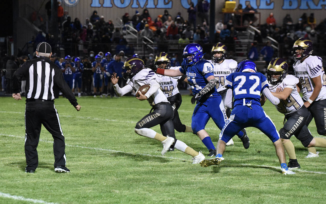 Wolverine Connor Haines, #14, picks up speed on the way to the goal line. (John Stimpson photo)