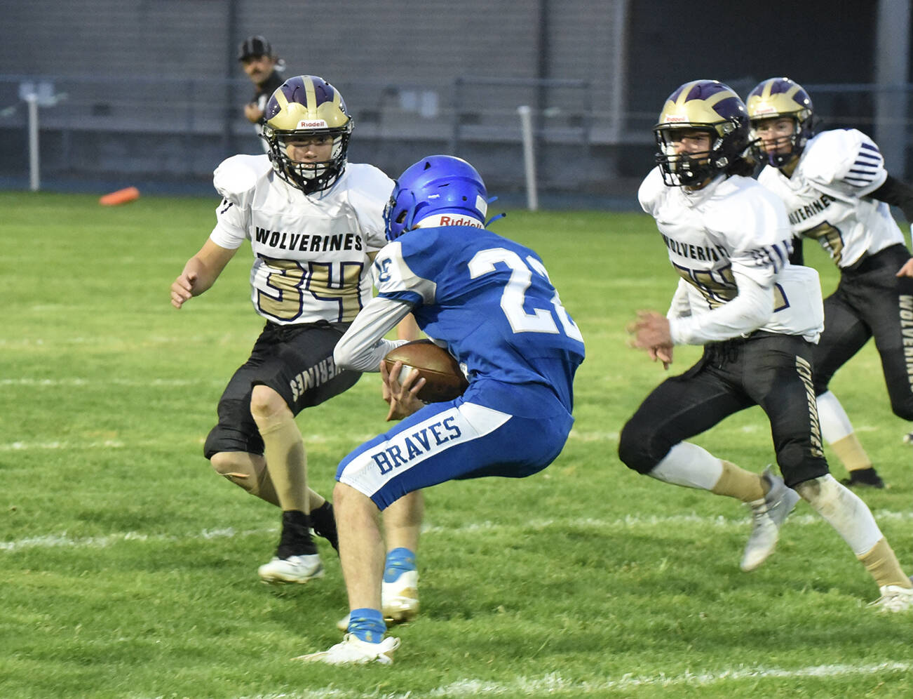 Wolverine Whiley McCutcheon, #34, and Connor Haines, #14, put a stop to the Braves running back. (John Stimpson photo)
