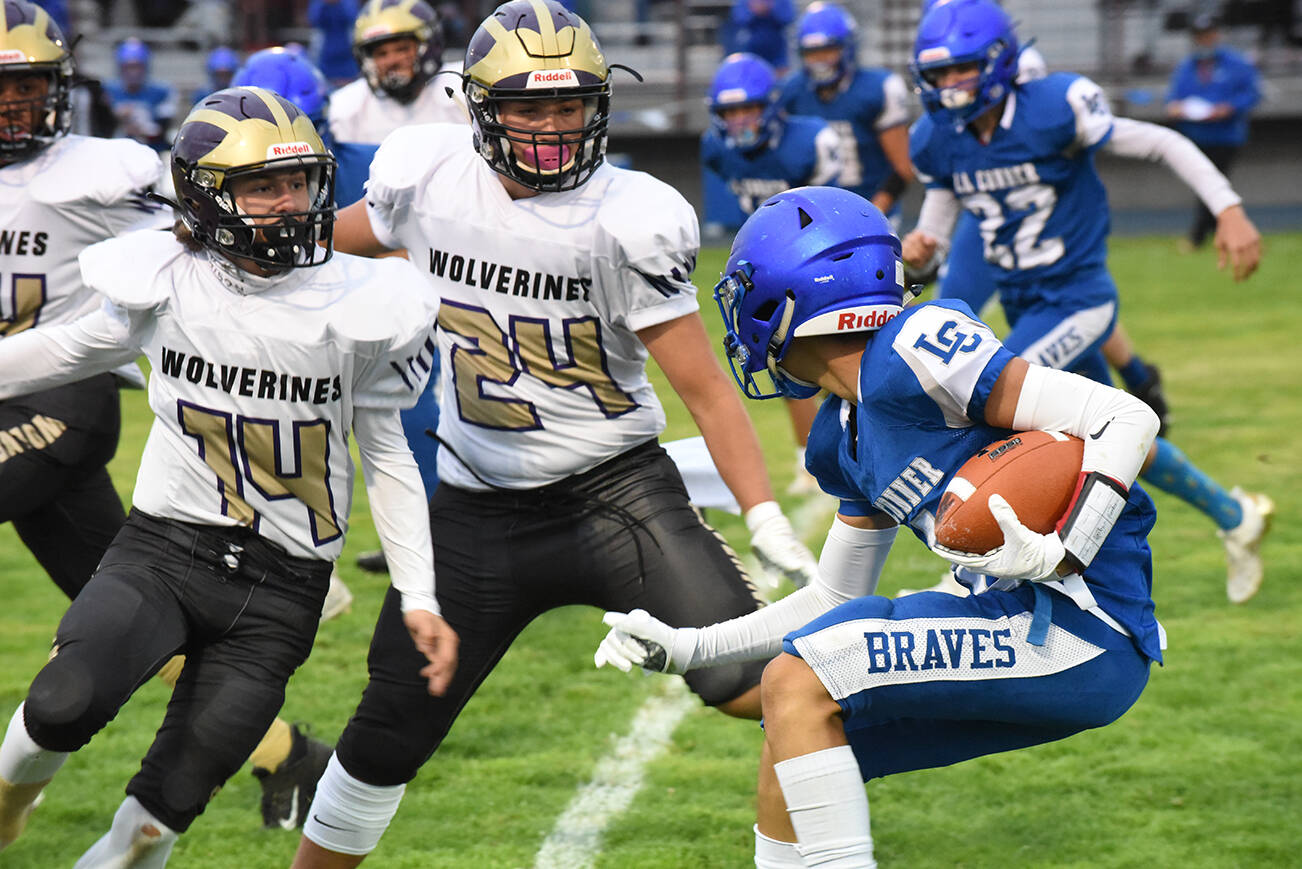 Connor Haines, #14, and Chris Gustafson, #24, to stop the La Connor Braves in their tracks. (John Stimpson photo)
