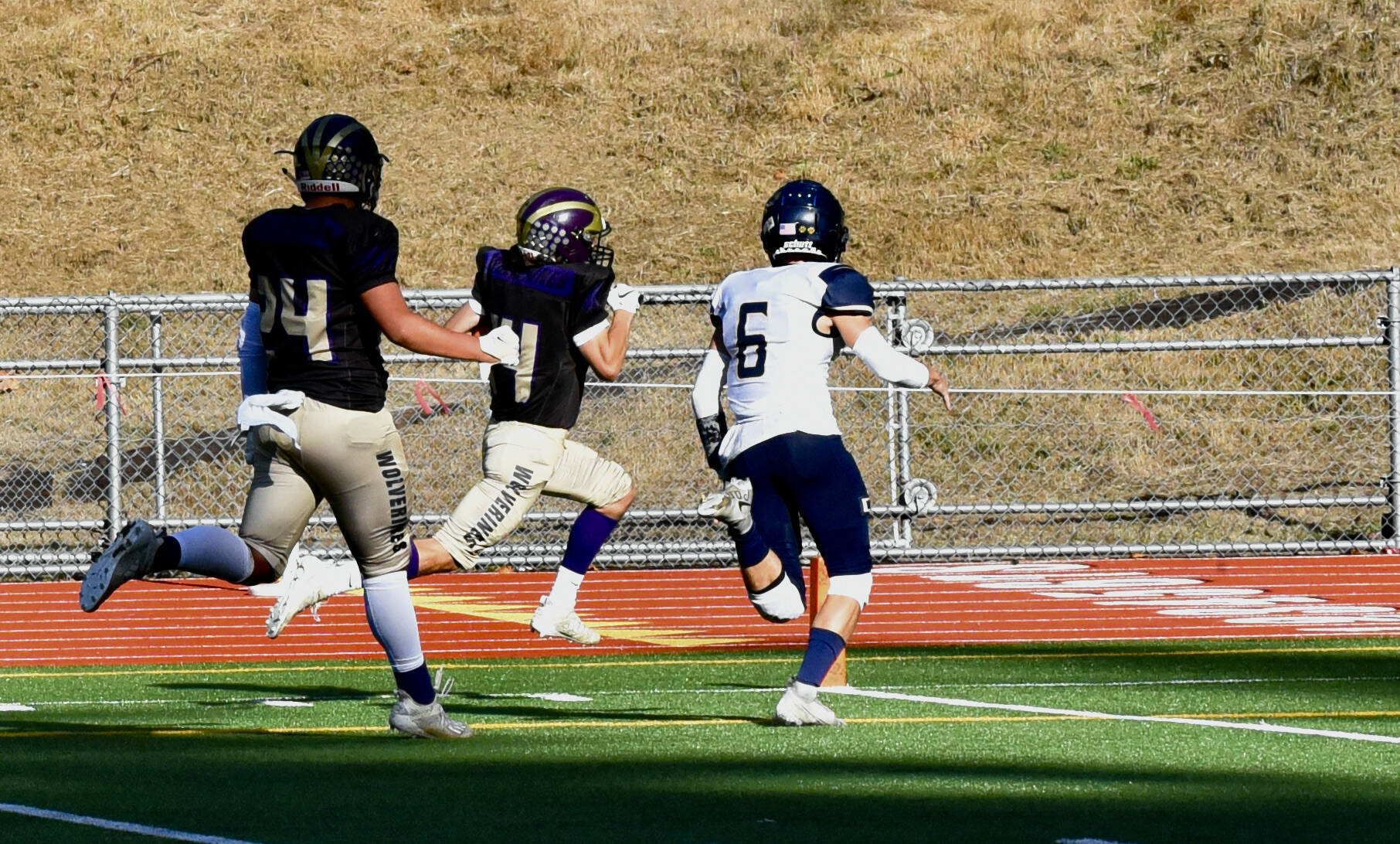 Wolverine Connor Haines, #14, races the baseline to score the first touchdown. (John Stimpson photo)
