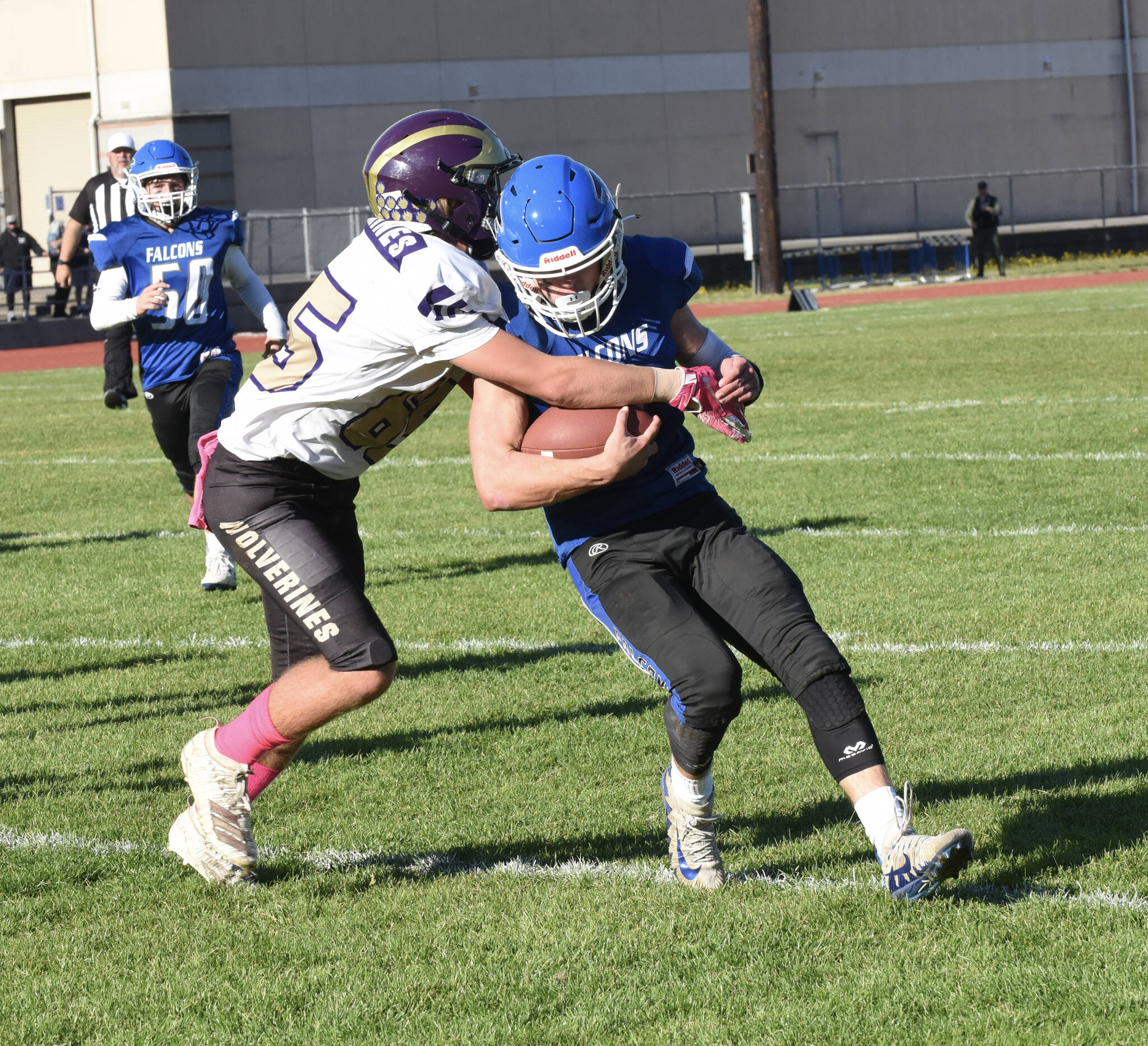 Wolverine Max Field, #65, forces Falcon running back out of bounds. (John Stimpson photo)