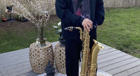 Contributed photo/ Breeann Huerta
Vince Huerto stands with his baritone saxophone.