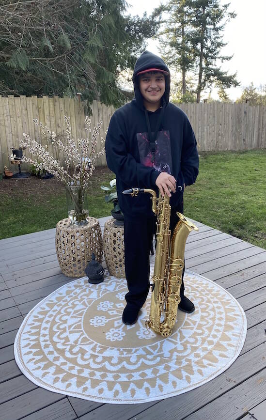 Contributed photo/ Breeann Huerta
Vince Huerto stands with his baritone saxophone.