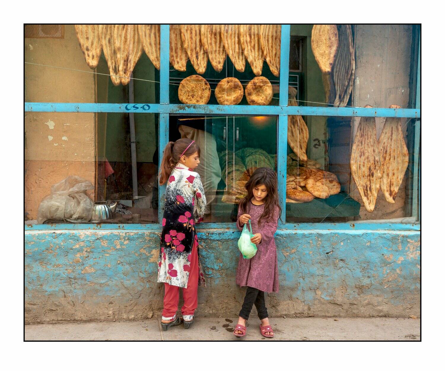 Girls in front of bakery. Photo by James Longley.