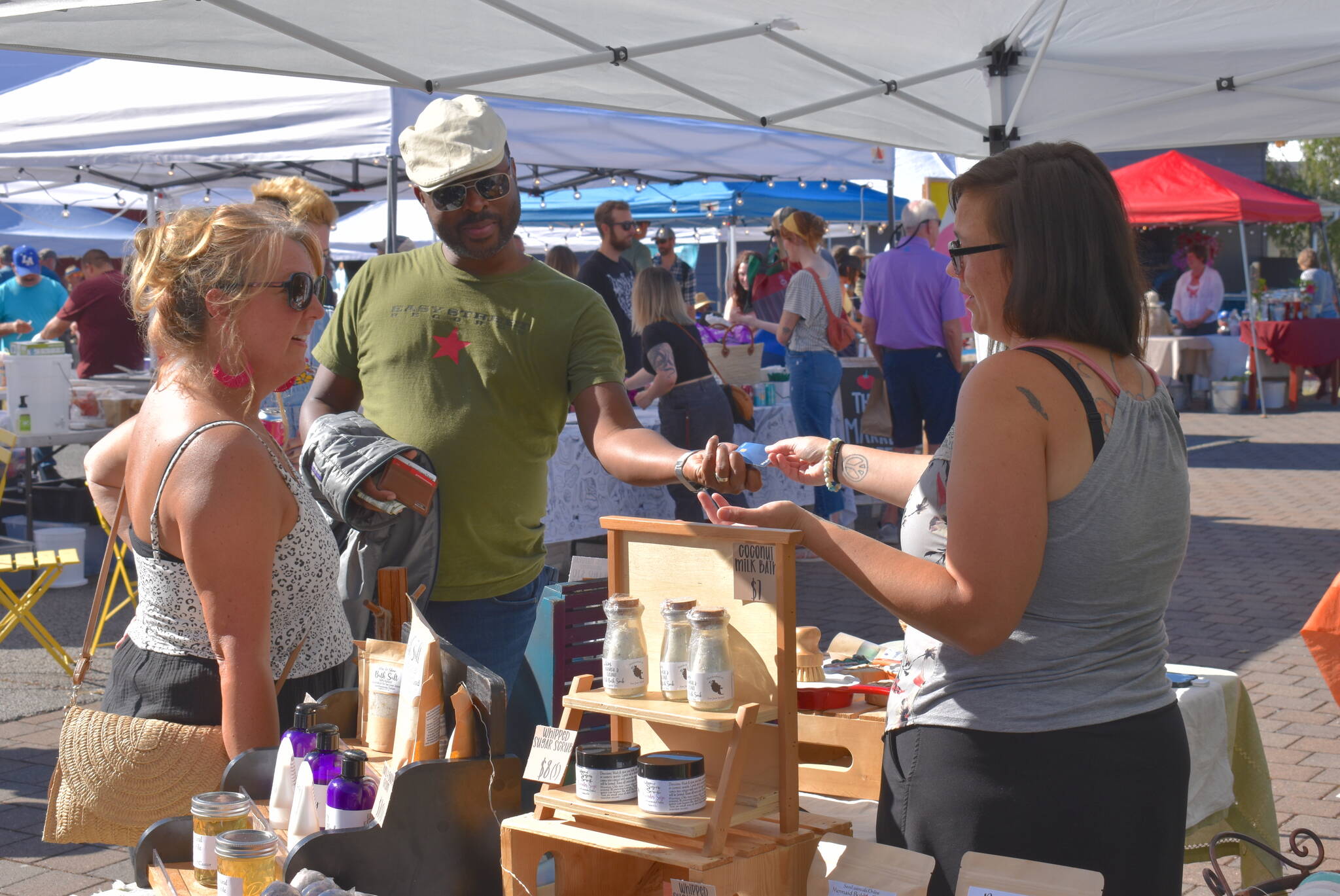 Shoppers in search of creative gifts enjoy the San Juan Summer Arts Festival.
