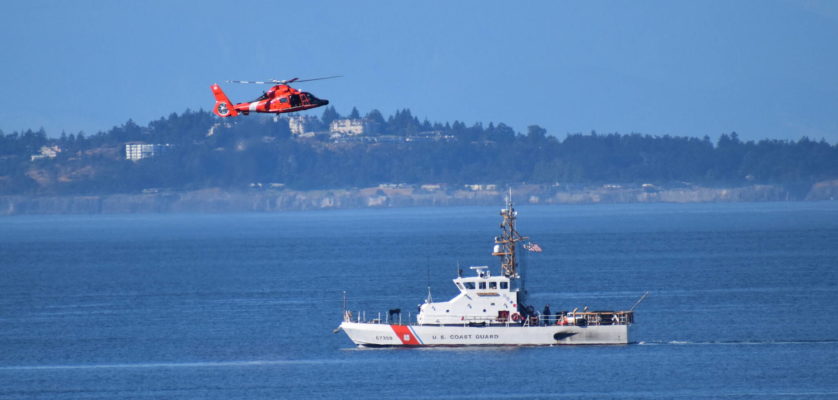 Kelley Balcomb-Bartok / Staff photo
US Coast Guard Cutter Swordfish stands by the scene of the vessel sinking as a Coast Guard helicopter flies overhead.