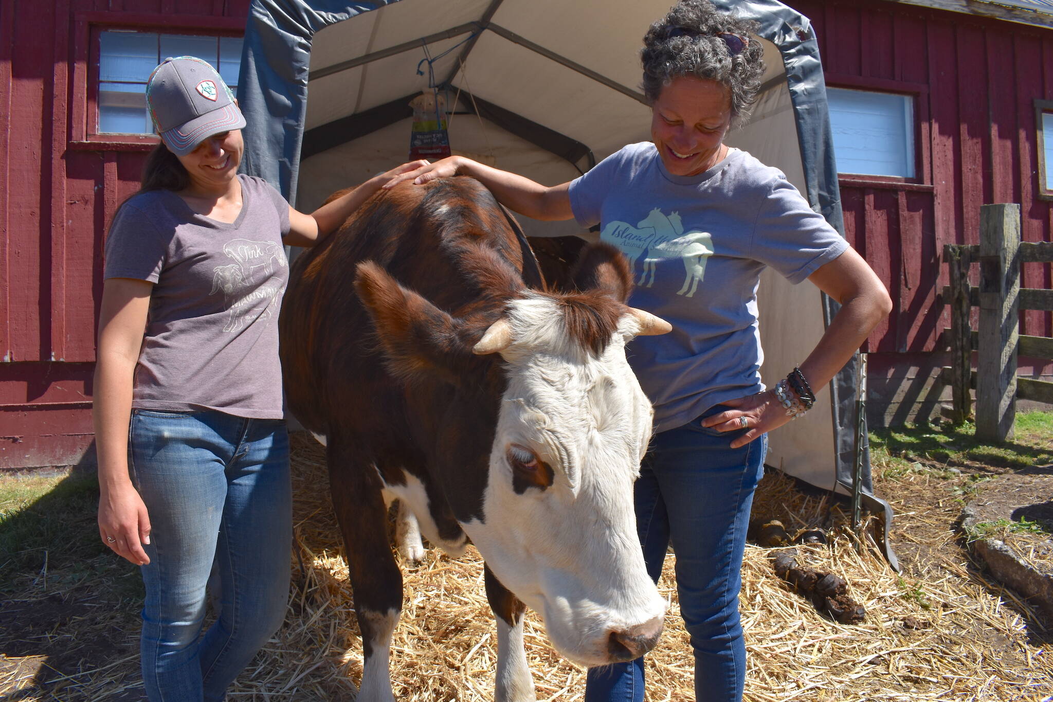 Kelley Balcomb-Bartok  Staff photo
Braunti Cobb and Julie Duke share a happy moment with Bessie, a milk cow the two bottle raised from a baby.