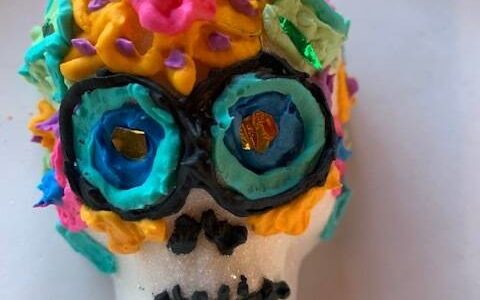 Heather Spaulding/Staff photo
A decorated sugar skull cookie and Dia de los Muertos dancers.
