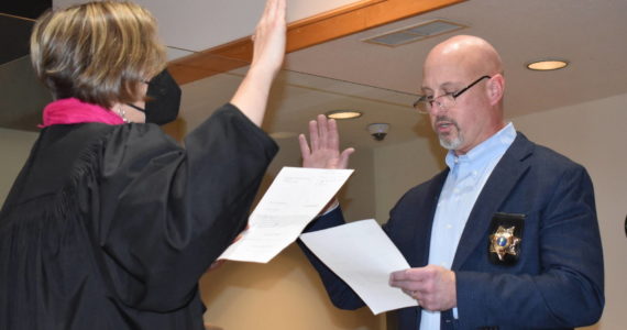 Kelley Balcomb-Bartok Staff photo
Newly Elected Sheriff Eric Peter is sworn in by Superior Court Judge Kathryn “Katie” Loring during an official ceremony Dec. 30 at the Superior Court courtroom.