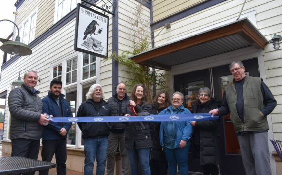 Kelley Balcomb-Bartok Staff photo
13 Ravens owner Liberty Miller is surrounded by members of the San Juan Island Chamber of Commerce during a ribbon-cutting event Tuesday, Feb. 28 celebrating her official opening. Members of the chamber include (l-r) Scott Sluis, Roberto Moya, Karl Bruno, David Cope, Liberty Miller, Deborah Hoskinson, Kris Brown, Executive Director Becki Day, and Steve Hushebeck.