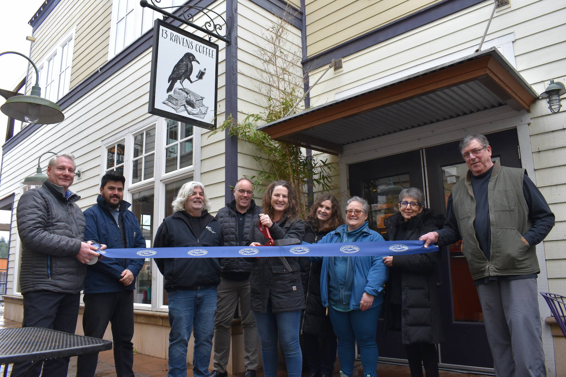Kelley Balcomb-Bartok Staff photo
13 Ravens owner Liberty Miller is surrounded by members of the San Juan Island Chamber of Commerce during a ribbon-cutting event Tuesday, Feb. 28 celebrating her official opening. Members of the chamber include (l-r) Scott Sluis, Roberto Moya, Karl Bruno, David Cope, Liberty Miller, Deborah Hoskinson, Kris Brown, Executive Director Becki Day, and Steve Hushebeck.