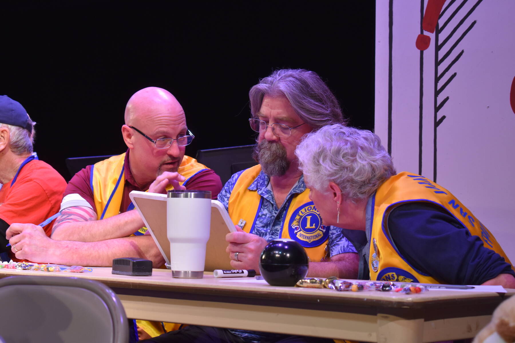 Lions Club members confer during the San Juan Public Schools Foundation’s 28th annual Knowledge Bowl.