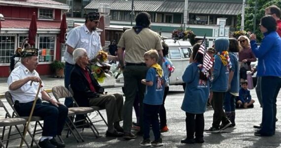 Heather Spaulding \ Staff photo
Young Cub Scouts were given flowers to toss into the harbor.