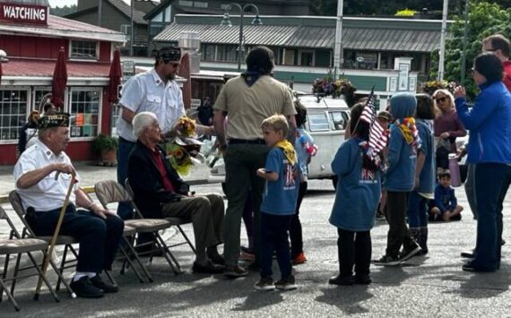 Heather Spaulding \ Staff photo
Young Sea Scouts were given flowers to toss into the harbor.