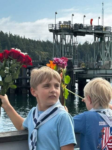 Heather Spaulding \ Staff photo
A Cub Scout waits for the cue to toss his flowers.