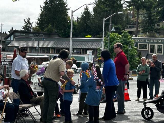 Heather Spaulding \ Staff photo
Cub Scouts get flowers to toss into the harbor.