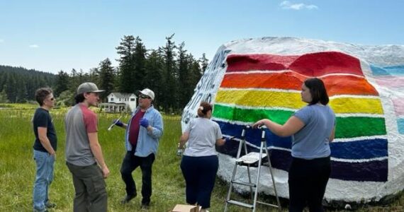 Heather Spaulding  Staff photo
Community members working to fix the vandalized Pride flag.