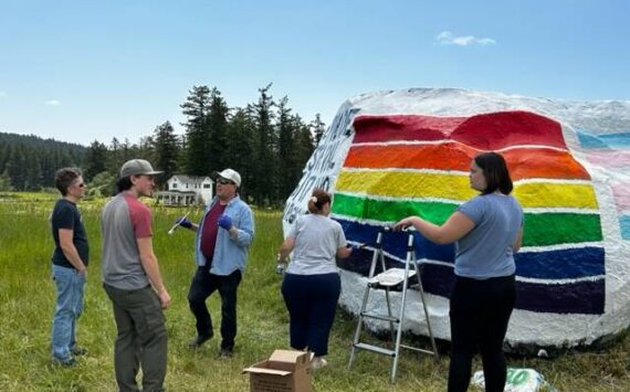 Heather Spaulding  Staff photo
Community members working to fix the vandalized Pride flag.