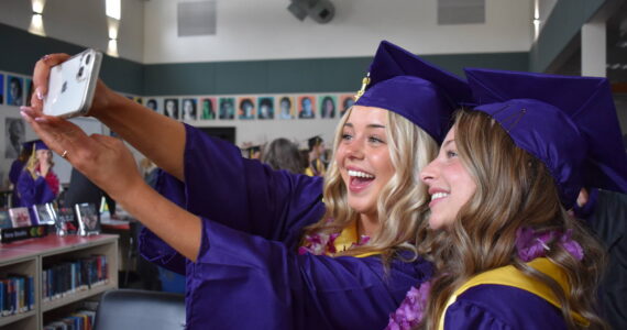 Kelley Balcomb-Bartok / Staff photo
ASB President Ayana Berube takes a ‘selfie’ with friend and classmate Meg Carrier in the high school library minutes before entering Turnbull Gym for the 111th Commencement of Friday Harbor High School.