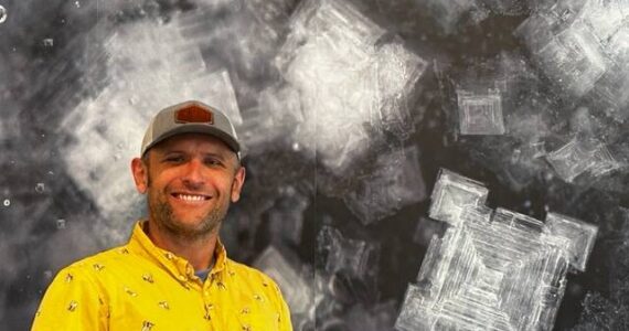 Heather Spaulding \ Staff photo
Brady Ryan in front of a large photo of salt crystals inside the new store.