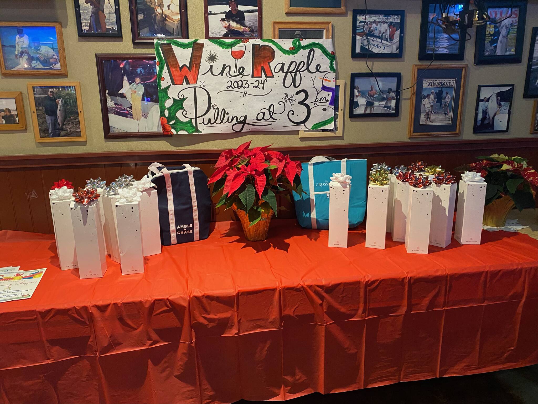 Isabel Ashley/Staff Photo
Bottles of wine were donated for a raffle at Haileys Bar and Grill, with proceeds going towards youth sports.