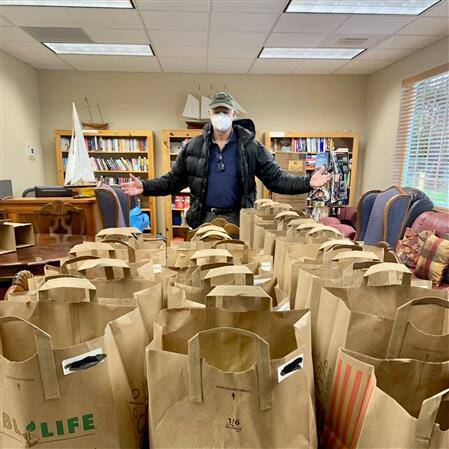 Contributed photo
Volunteer Paul Mayer and 36 Weekends family food supplement bags.