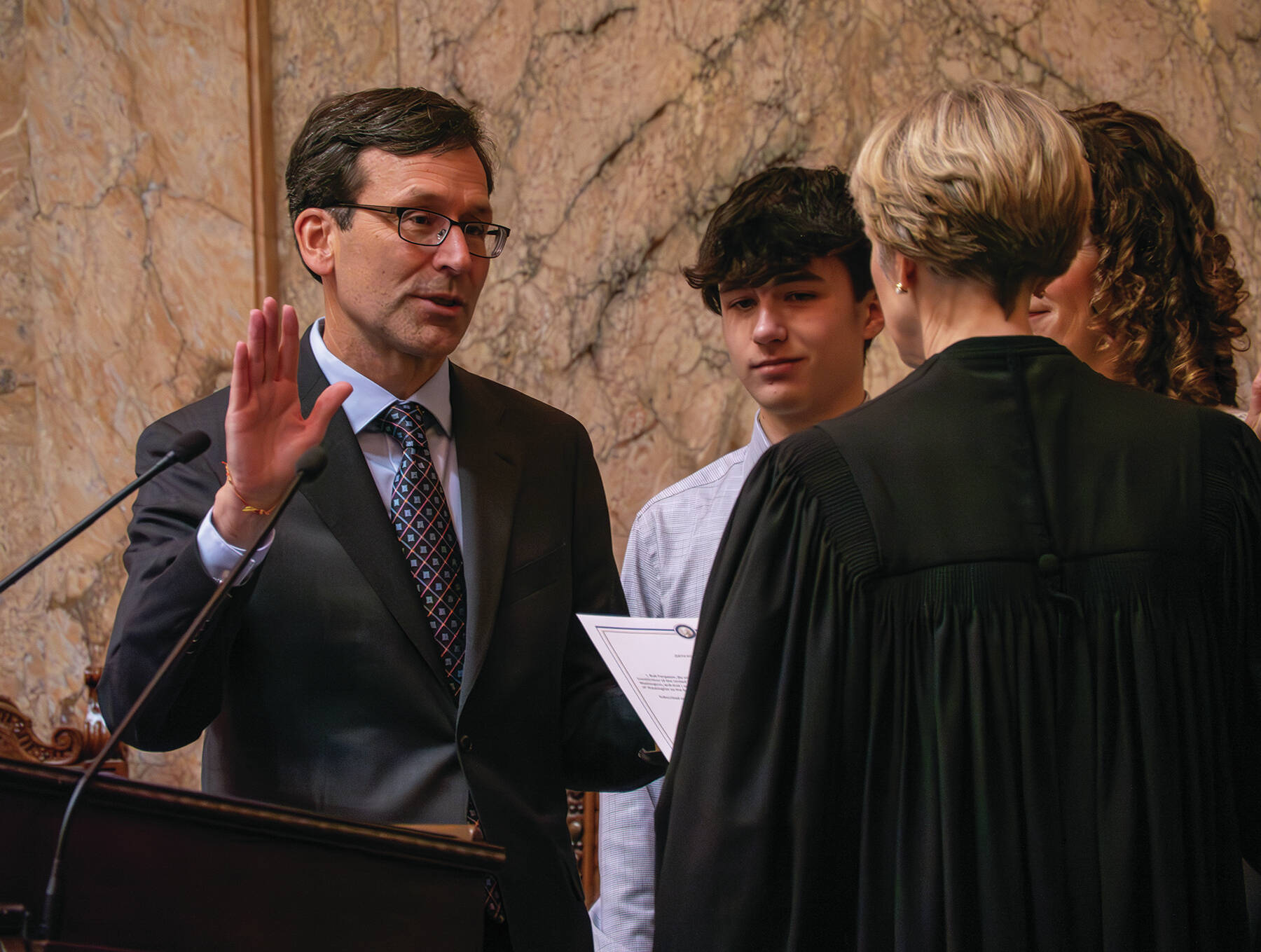 Gov. Bob Ferguson is sworn into the office Jan 15. in Olympia. With him were his twins, Jack and Katie, and his wife, Colleen Ferguson. Photo by Juan Jocom.