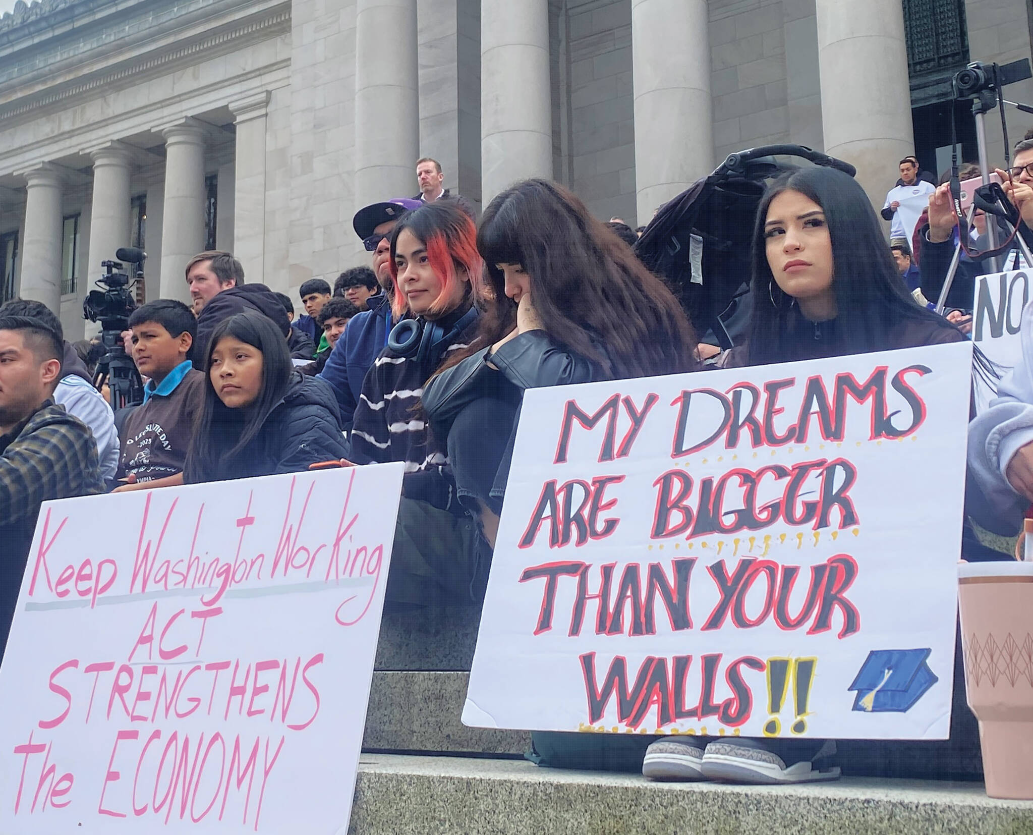 Protesters held up signs in support of Latino culture and immigrants to the United States. Mary Feusner photo.