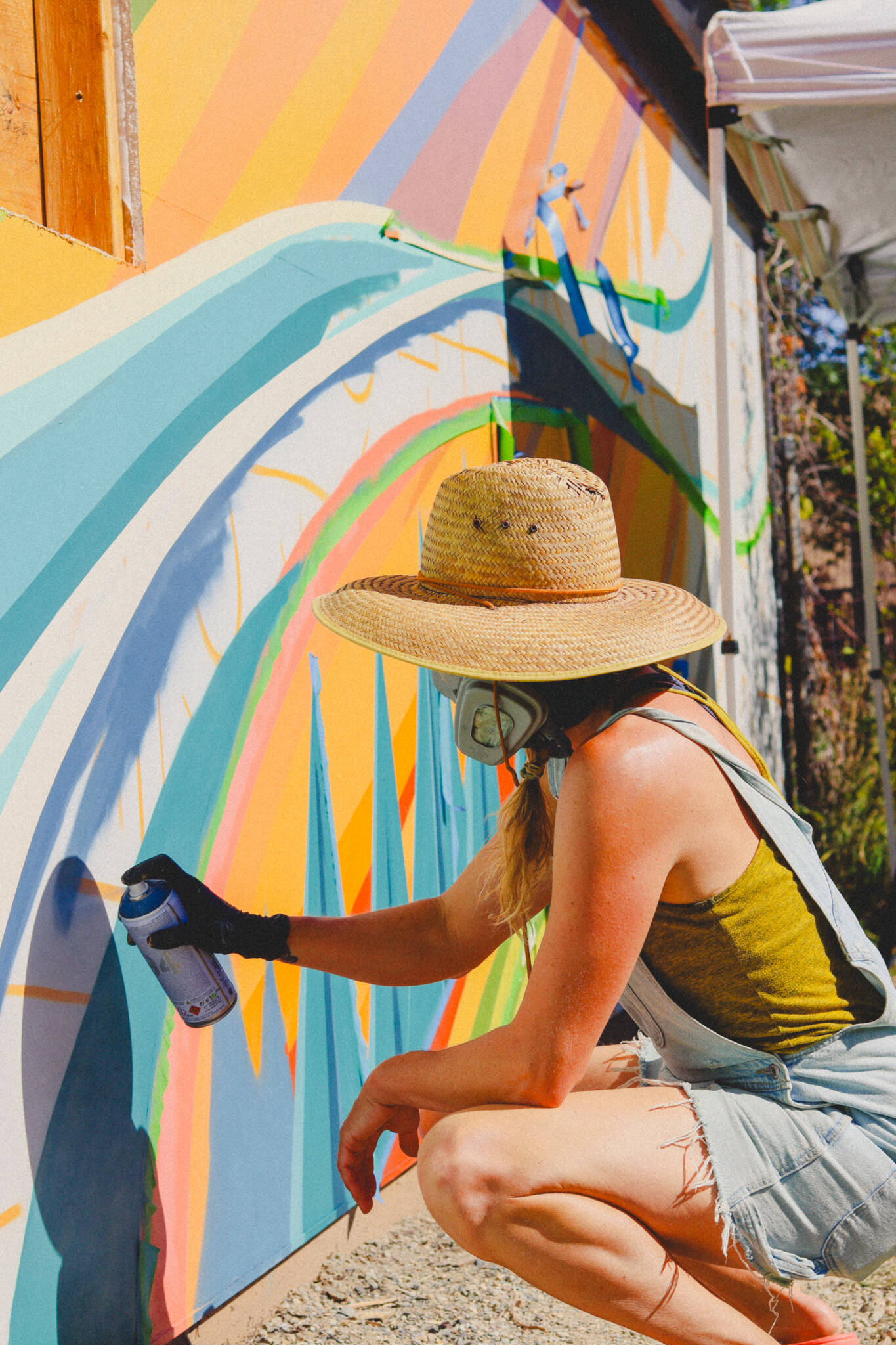 Stephen Mitchell photo.
A woman spray paints a mural.