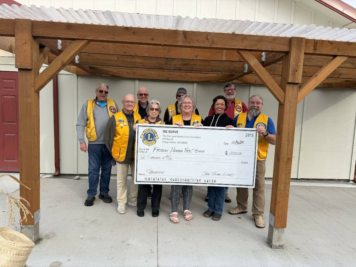 Contributed photo.
Lions with the Friday Harbor Food Bank manager Rachelle Radonski.