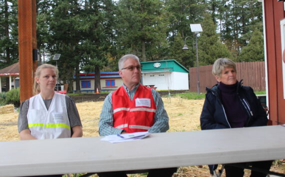 Heather Spaulding/staff photo.
Jessica Hudson, Mark Thompkins and Kari McVeigh listen as Brendan Andrews provides a briefing.