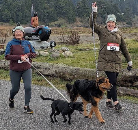 Runners and dogs reach the finish line.