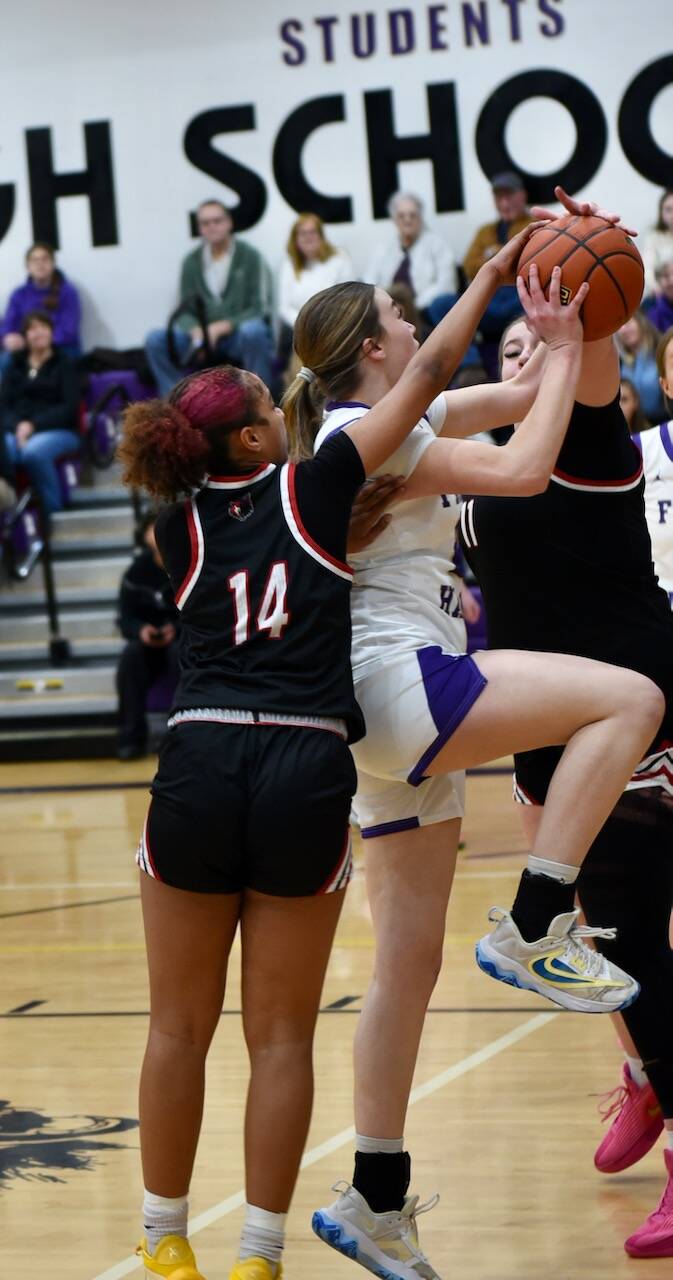 Contributed photo by John Stimpson
Ila Allen, #20, scores two points under pressure from the Wolves.