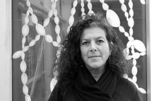 Dana Lynn Louis in front of a segment of her glass painting.