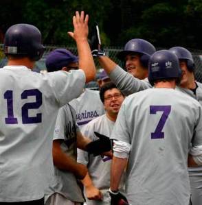 Former Wolverine baseball player Jacob Ross accepts a tall high-five for a short home run -- 286 feet -- in last year's inaugural alumni baseball game.