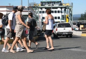 Pedestrians sauntered along Front Street as a vehicle unload off a ferry in reverse at the Friday Harbor ferry landing.