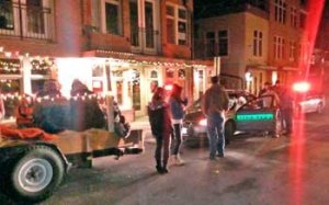 Far right; deputies question the driver of a trailer decorated with holiday lights and carrying Christmas carolers during a traffic stop in downtown Friday Harbor on Christmas Eve.