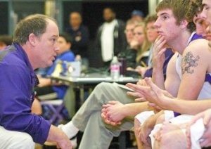 Coach Rod Turnbull provides instructions to his players during a hotly contested game at home.