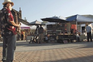 Local musician Teddy Deane serenades shoppers with a few tunes on the saxophone as part of the inaugural  Art Market event
