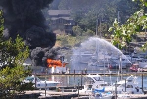 The fireboat Confidence sprays a stream of water on an 85-foot yacht fully engulfed in flames at Roche Harbor Resort at about 12:30 p.m.