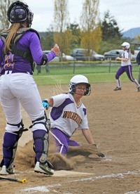 Emily Guard slides in safe at home to score the first of the Wolverines 14 runs in a victory over Concrete at home