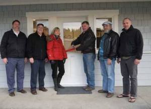 Port Commissioner Mike Ahrenius cuts the ribbon at the opening the airport's newly constructed Pilot Welcome Center