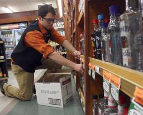 Tyler Felton restocks the shelves at the liquor store in Friday Harbor
