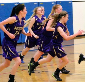 The Wolverines charge the court during a Tuesday game.