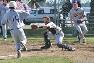 Catcher Peter Holt readies to make a play at the plate