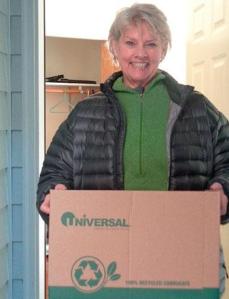 On the move: Susan Feldmiller carries a box of personal possessions to yet another new location