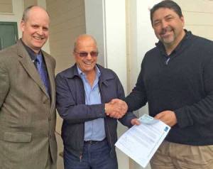 Flanked by School District Superintendent Rick Thompson