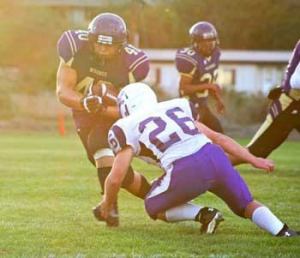 Friday Harbor's Nate Steenkolk powers into the end zone for one of his two rushing touchdowns in the Wolverines 20-19 loss to Anacortes