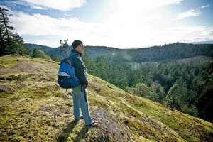 A hiker takes in the sweeping views of San Juan Island and beyond from the crest of the would-be Mount Grant nature preserve.